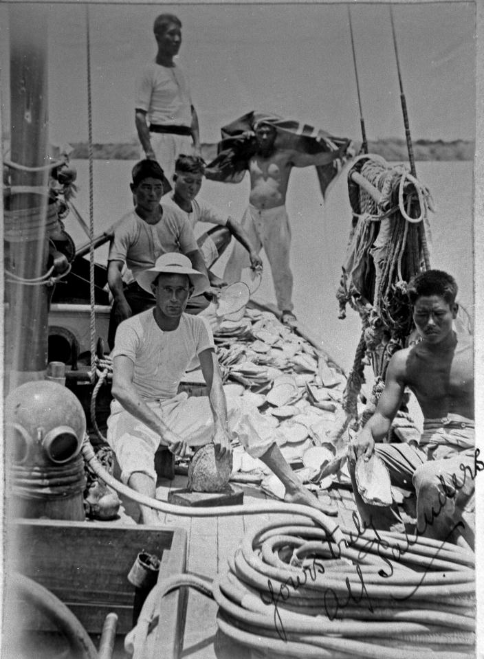 A group of people working on the deck of a boat. 